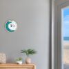Tidal Timepieces Aqua Horizon tide clock in an entryway of a coastal home.
