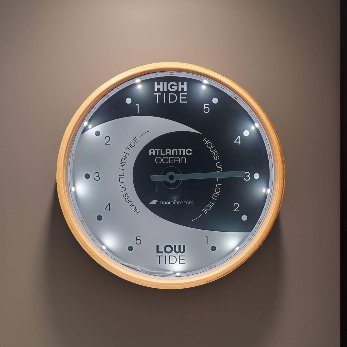 Tidal Timepieces' Tidal Eclipse LED tide clock hanging on a wall.