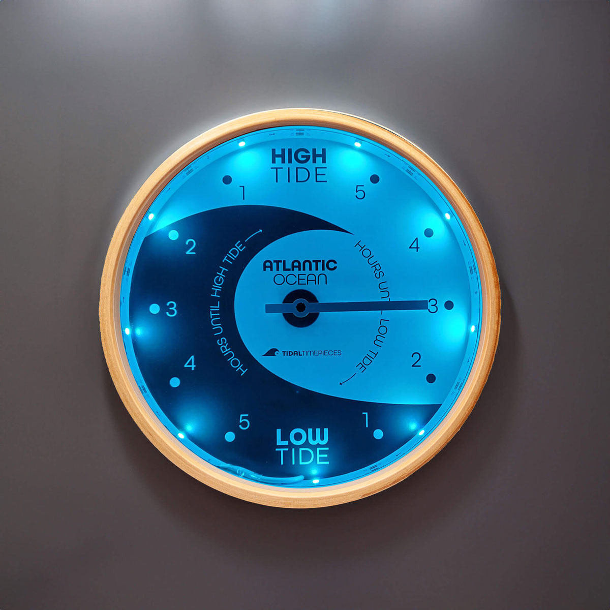 Tidal Timepieces' Yin and Yang Eclipse LED tide clock hanging on a wall.