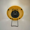 Rear view of tide clock sitting in stand.